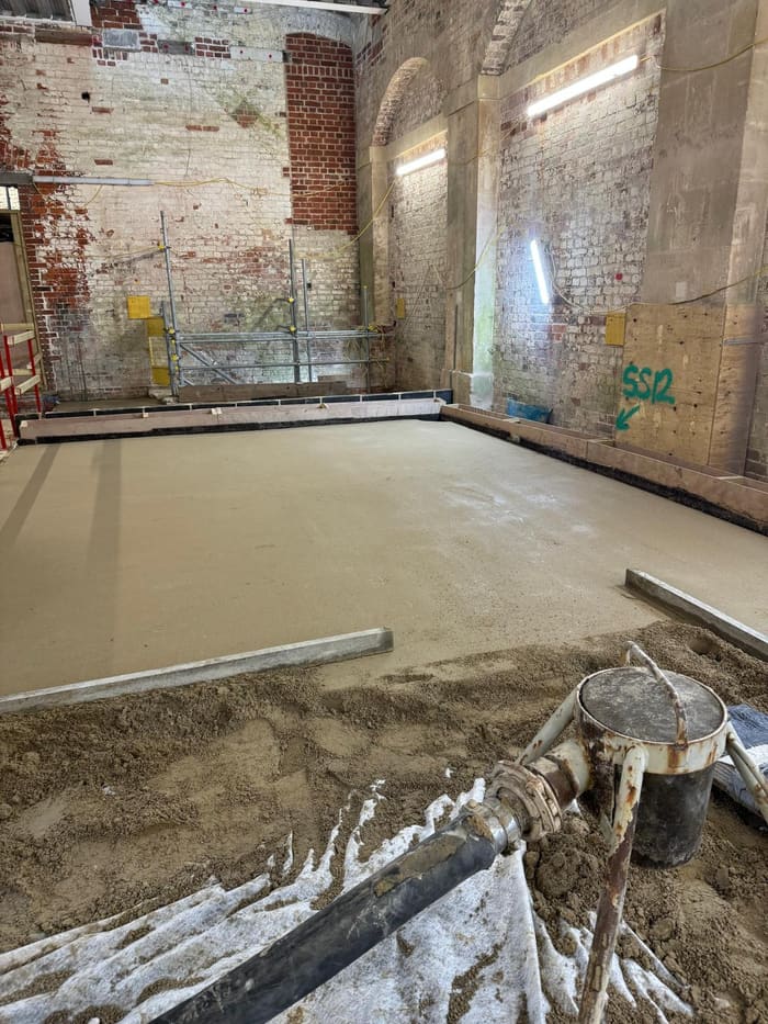 Freshly poured limecrete slab in a heritage brick building